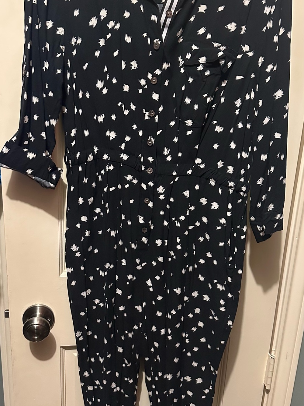 Vince Camuto black & white spot print, button-front jumpsuit.